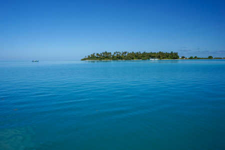 Uninhabited tropical island with palm trees. empty space with beautiful turquoise lagoonの写真素材