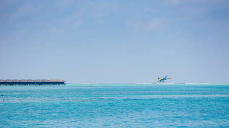 landing of a seaplane on the turquoise maldivian lagoon. luxurious travel conceptの写真素材