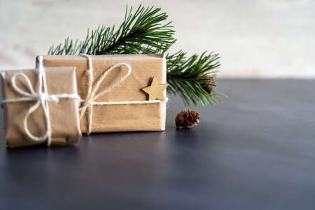 Christmas and zero waste, eco friendly packaging. wrapped gifts in craft paper with wooden...