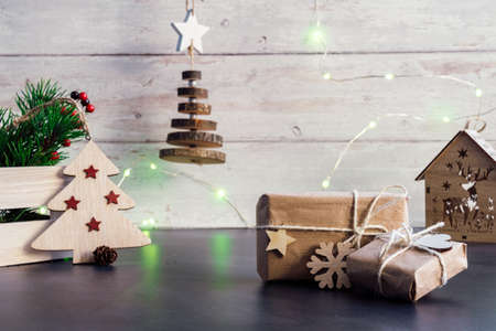 Christmas and zero waste, eco friendly packaging. wrapped gifts in craft paper with wooden...