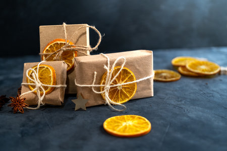 Zero waste Christmas concept. Eco-friendly kraft paper wrapping gifts on a slate table. DIY gifts,...