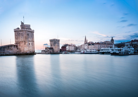 La rochelle harbor at sunset. Panorama skyline. the famous towers of La Rochelle are illuminated with christmas light.の写真素材