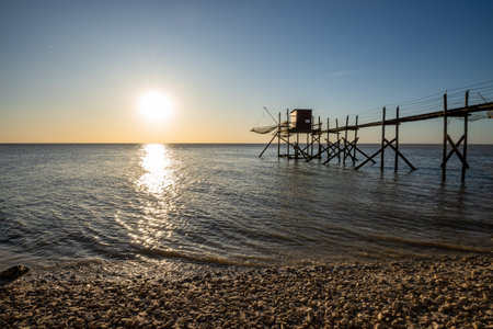 Fishing hut on stilts coast of Atlantic ocean at sunset near La Rochelle, Charente Maritime, Franceの写真素材