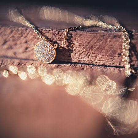 magnificent necklace on a vintage wooden bark. romantic story. Macro shot.の写真素材