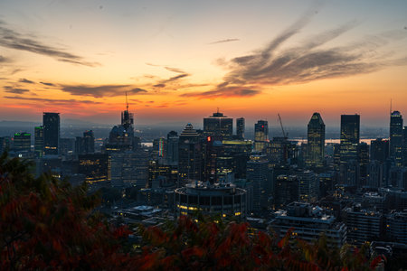 Montreal sunrise from Mont Royal Kondiaronk Belvedere with colorful leaves. Panoramic skyline view of downtown Montreal from top view at sunrise in Canadaの写真素材