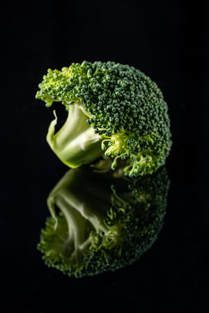 broccoli isolated on black background with reflection. portrait formatの写真素材