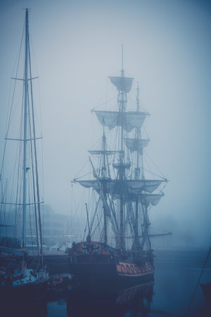 A ghost ship moored in the misty port of La Rochelleの写真素材