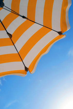 Beach umbrella against blue morning skyの写真素材