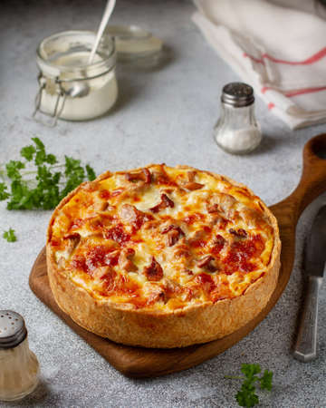 Quiche of shortcrust pastry with chanterelle mushrooms and cheese with a golden brown crust on a...