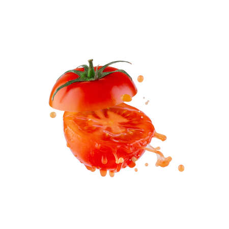 Ripe tomato cut in half with splashes and drops of juice, isolateの写真素材