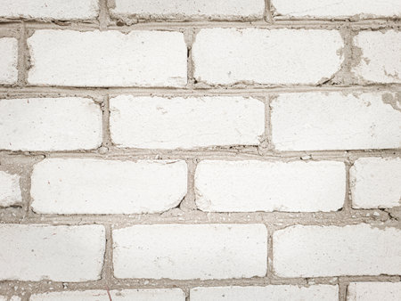 Wall of white even bricks, background with copy space