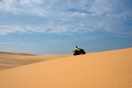 ATV racing drive on sand dune.の写真素材