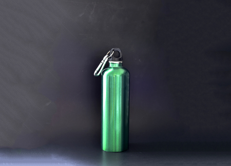 Green metal Flask bottle silhouette on blackの写真素材