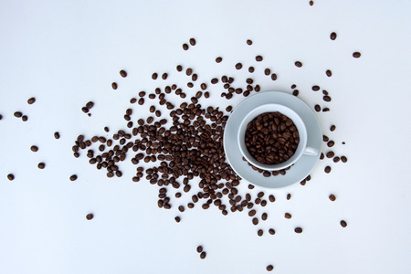 Coffee beans and cup of coffee on white backgroundの写真素材