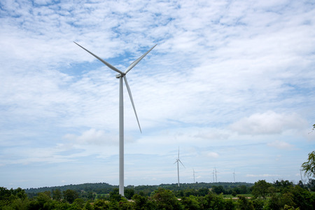 Windmills tower for electric power production, white tower on blue sky background