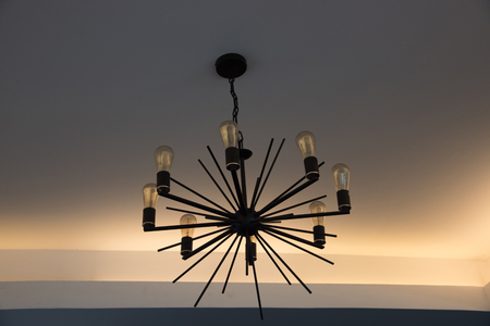 Modern chandelier lamp on white background hanging on the ceilingの写真素材