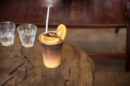 Colombia ice coffee mixed with orange juice on topping a piece of fresh orange