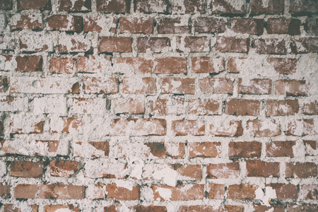Background of old vintage dirty brick wall with plaster,  Brick wall background texture with faded effect, Painted distressed wall surface, Vintage red stonewall backgroundの写真素材