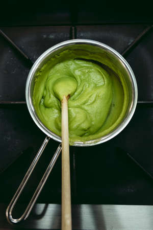 Frozen spinach in the pot - prepared to cook. Green balls of frozen spinach - cuisine concept.の写真素材