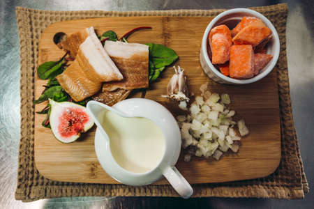 Ingredietns to preparing the cod fish fillet with orange soup with sweet potatoes and other tasty vegetables - photo from above.の写真素材