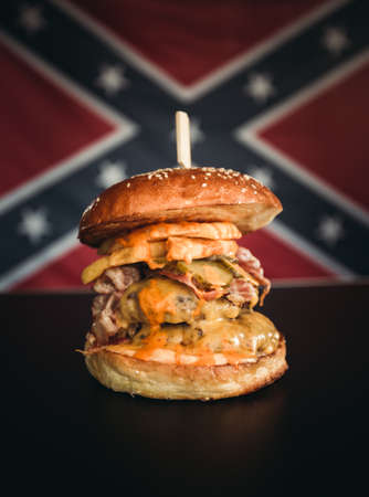 Vertical photo of american hamburger with chuck roll meat, cheddar cheeese and fries.の写真素材
