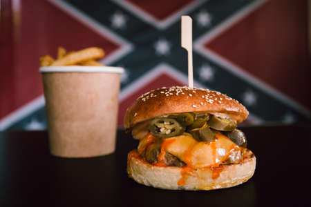 Photo of american hamburger with chuck roll meat, cheddar cheeese and fries.の写真素材