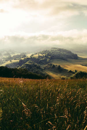 Beautiful scenic view of valley and big hills in Slovakia on sunset with misty cloudy sky. Perfect...