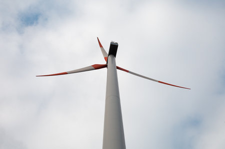 Detail of wind turbine against blue sky. Renewable energy  - ecological concept.  Close up photo of windmill with cloudy blue sky.の写真素材