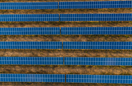 Aerial horizontal photo - top view of huge Solar Energy Plant on field in Europe - with beautiful...