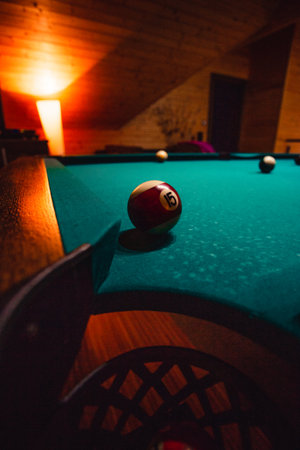 Vertical detailed photo of pool (billiard) balls on cozy warm backround with orange lighting. Close up image of colorful billiard balls.の写真素材