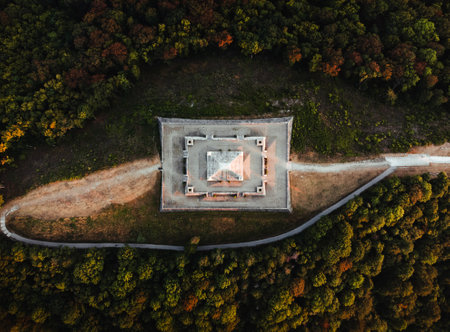 Aerial photo by drone of The Barrow (cairn) of Milan Rastislav Stefanik upon Hill with beautiful green trees around - on sunset. top view of The Barrow of Stefanik on sunset - golden hour.の写真素材