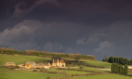 An English country farm taken with a storm approachingの写真素材