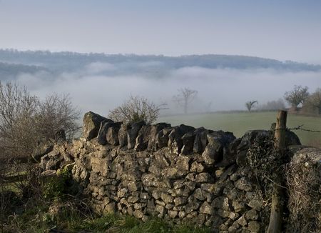 A misty morning view over a dry stone wallの写真素材