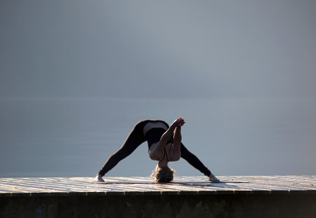 Female practicing yoga by Cultus lake in British Columbiaの写真素材