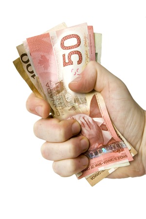 Hand grabbing canadian dollarsの写真素材