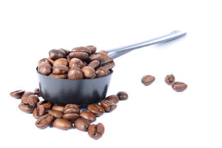 Coffee beans in spoonの写真素材