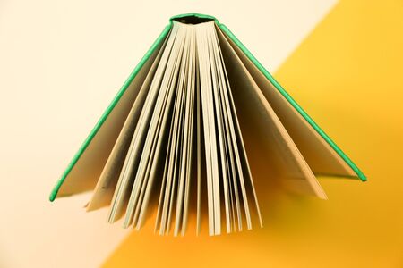Open book with dual tone background. Hardcover book open pages.