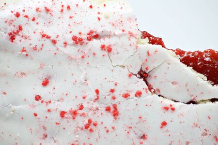 Icing background with bite , icing with red sprinkles backgroundの写真素材