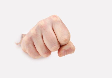 Hand punching through paper.Hand making fistの写真素材