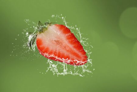 Fresh Strawberry on green background, Water splash and bright strawberry.の写真素材