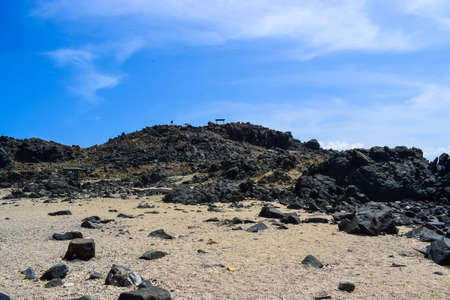 Arikok Natural Park on the island of Aruba in the Caribbean Sea with deserts and ocean waves on the rocky coastの写真素材