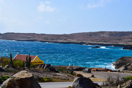 Arikok Natural Park on the island of Aruba in the Caribbean Sea with deserts and ocean waves on the rocky coastのeditorial素材