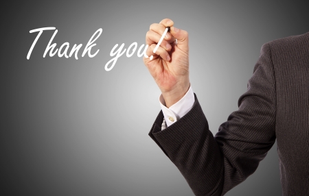 businessman write 'thank you' on glassの写真素材