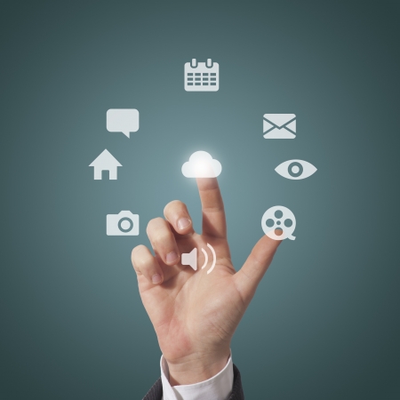 business man touching icons on screen, grey backgroundの写真素材