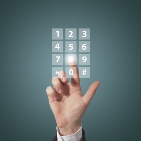 business man compose telephone number on screen, blue backgroundの写真素材