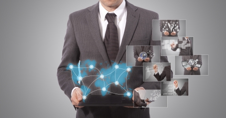 business man holding a tablet, grey background  world map from www lib utexas eduの写真素材