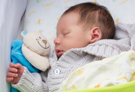 close-up portrait of a beautiful sleeping baby in his cradleの写真素材