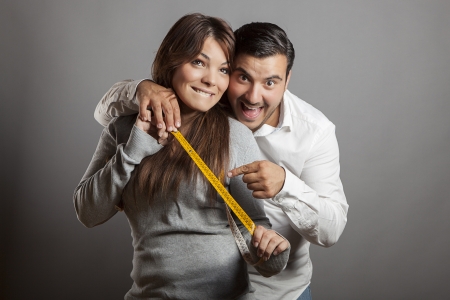 The boldness couple shows the sex length with a tape measureの写真素材