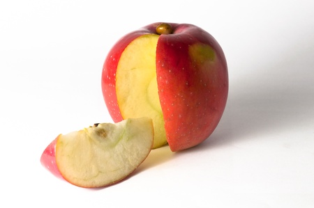 Sliced red apple with a slice on a white backgroud.の写真素材