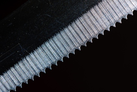 Macro shot of a kitchen knife blade on a dark blackground 